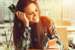 Young woman holding a VeraCash card